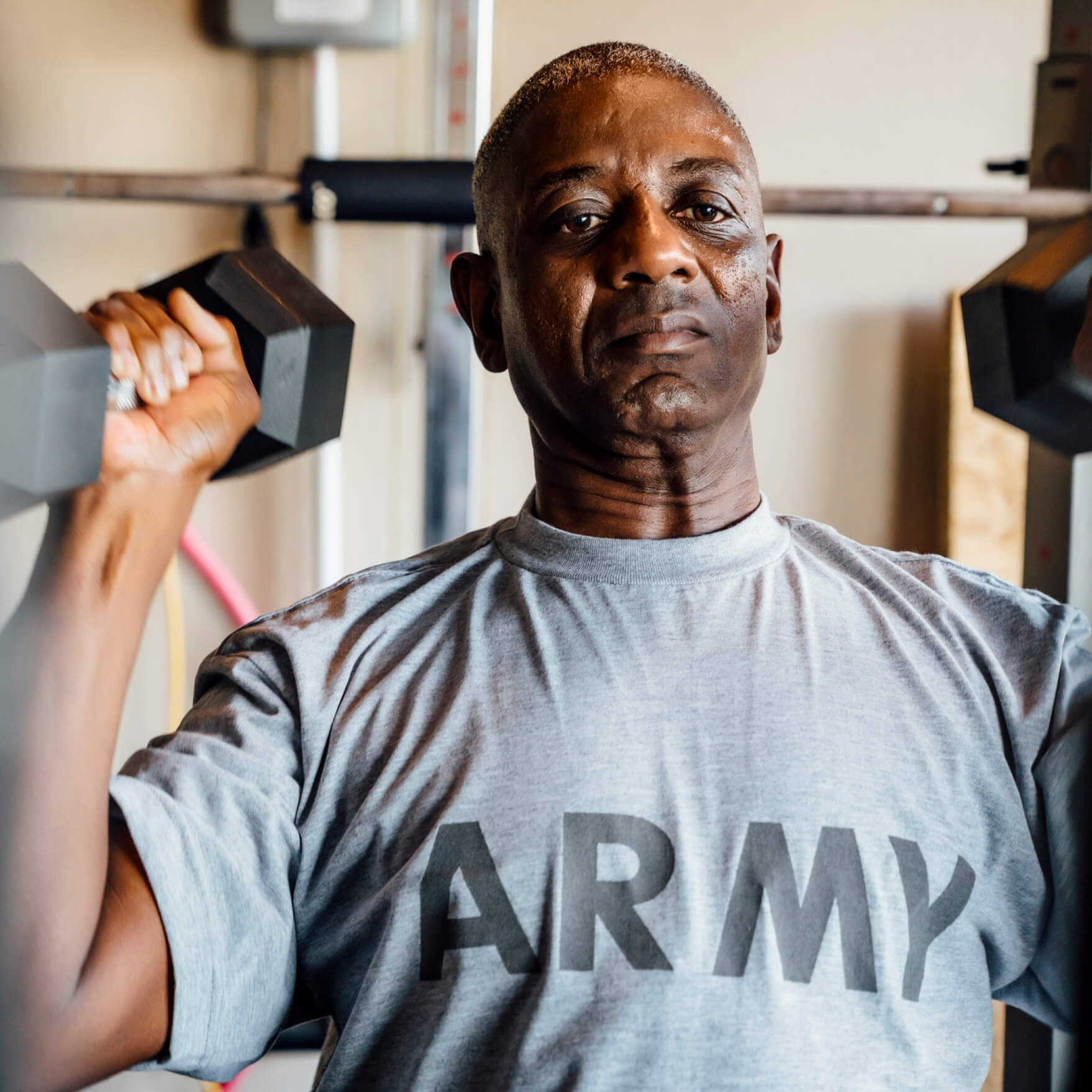 Capital One military associate lifting dumbbells